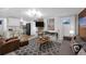 Open living space featuring exposed brick, comfortable seating, and a view into the modern kitchen area at 1351 N Franklin St, Denver, CO 80218