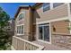 Exterior view of the home showing a wooden deck, slider and stone facade at 10646 Amesbury Way, Highlands Ranch, CO 80126