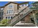 View of the back of the home from the yard, showing stairs and deck at 10646 Amesbury Way, Highlands Ranch, CO 80126