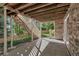 Covered back patio with stone facade, view of stairs, yard and fence at 10646 Amesbury Way, Highlands Ranch, CO 80126