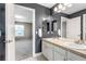 Double vanity in a bathroom with tile floors and grey walls and a view to the bedroom at 10646 Amesbury Way, Highlands Ranch, CO 80126