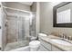 Full bathroom featuring glass shower doors, granite countertops, and a decorative mirror at 10646 Amesbury Way, Highlands Ranch, CO 80126