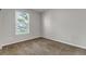 Bright bedroom with plush carpet and a window with tree views at 10646 Amesbury Way, Highlands Ranch, CO 80126