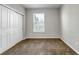 Bedroom featuring neutral carpet, window, and closet for comfortable living at 10646 Amesbury Way, Highlands Ranch, CO 80126