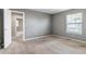 Empty room with grey walls, beige carpet, and a single window with blind coverings at 10646 Amesbury Way, Highlands Ranch, CO 80126
