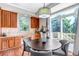 Bright dining area with wood floors, wood cabinets and sliding glass doors to the deck at 10646 Amesbury Way, Highlands Ranch, CO 80126