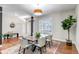 Cozy dining area with natural light, a wooden table with seating, hardwood floors and view to the entryway at 10646 Amesbury Way, Highlands Ranch, CO 80126