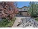 Two-story home showcasing a well-manicured front lawn, a two-car garage, and a welcoming front porch at 10646 Amesbury Way, Highlands Ranch, CO 80126