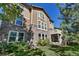 Two-story home featuring a stone and siding exterior, a deck, and a well-maintained backyard at 10646 Amesbury Way, Highlands Ranch, CO 80126