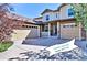 Charming two-story home with a three-car garage, stone accents, and well-maintained landscaping, ideal for suburban living at 10646 Amesbury Way, Highlands Ranch, CO 80126
