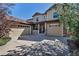 Spacious home with a three-car garage, stone accents, a covered front porch, and mature landscaping at 10646 Amesbury Way, Highlands Ranch, CO 80126