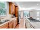 Bright kitchen showcasing wooden cabinets, stainless steel appliances, granite countertops, and hardwood floors leading to an eating area at 10646 Amesbury Way, Highlands Ranch, CO 80126