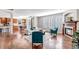 Spacious living room featuring hardwood floors, fireplace, white sofa and open to the kitchen at 10646 Amesbury Way, Highlands Ranch, CO 80126