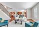 Spacious open-concept living area with stairs, hardwood floors, leading to a kitchen with stainless appliances and a dining area at 10646 Amesbury Way, Highlands Ranch, CO 80126