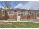 Charming brick home with well-maintained lawn, sidewalk, and front door under a partly cloudy sky at 1537 Xenia St, Denver, CO 80220