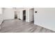 Bright living room with new gray flooring, white walls, and modern trim, offering a spacious feel at 1537 Xenia St, Denver, CO 80220