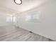 Inviting living room with large windows, new gray flooring, and fresh white paint for a bright modern look at 1537 Xenia St, Denver, CO 80220