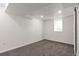 Bedroom featuring a window, soft carpet, white trim and baseboards, and easy access to closet at 5261 Chandler Way, Denver, CO 80239
