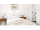 Bright bedroom featuring two bedside tables, stylish lamps and an adjacent entry door at 5261 Chandler Way, Denver, CO 80239