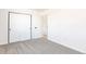Spacious bedroom with plush carpeting, a sizable closet, and an attached entry door at 5261 Chandler Way, Denver, CO 80239