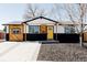 Striking exterior featuring a modern color scheme, natural wood accents, and a well-maintained front yard at 5261 Chandler Way, Denver, CO 80239