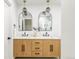 Double vanity bathroom with marble countertops and arched mirrors at 2809 Forest St, Denver, CO 80207