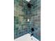 Modern bathroom with teal tile shower and bathtub at 2809 Forest St, Denver, CO 80207