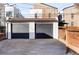 Two-car garage with dark gray doors and a concrete driveway at 2809 Forest St, Denver, CO 80207