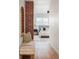 Hallway with exposed brick and a view into a bedroom at 2809 Forest St, Denver, CO 80207