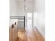 Light-filled hallway with wood floors and modern light fixture at 2809 Forest St, Denver, CO 80207