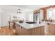 Modern kitchen with light wood cabinets, quartz countertops, and exposed brick at 2809 Forest St, Denver, CO 80207