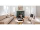 Living room with a green tile fireplace, hardwood floors, and natural light at 2809 Forest St, Denver, CO 80207