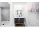 Modern bathroom with gray tile, floating vanity, and bathtub at 3100 E Cherry Creek South Dr # 903, Denver, CO 80209