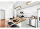 Modern white kitchen with wood countertops at 3100 E Cherry Creek South Dr # 903, Denver, CO 80209