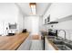 Modern white kitchen with wood countertops at 3100 E Cherry Creek South Dr # 903, Denver, CO 80209