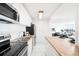 Modern white kitchen with wood countertops at 3100 E Cherry Creek South Dr # 903, Denver, CO 80209