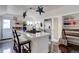 Bright kitchen features stainless steel refrigerator, island, white cabinets, and stylish decorations at 737 La Farge Ave, Louisville, CO 80027