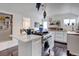 Open kitchen view with stainless steel appliances, an island, and hardwood floors at 737 La Farge Ave, Louisville, CO 80027