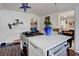 A kitchen island features a stainless steel cooktop and a white countertop at 737 La Farge Ave, Louisville, CO 80027