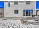 Backyard view showcasing patio, sliding doors, and snowy landscape at 1886 Makley Loop, Castle Rock, CO 80104