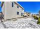 Fenced backyard with patio, snowy ground, and neighboring houses at 1886 Makley Loop, Castle Rock, CO 80104