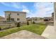 Home backyard with beautiful green lawn, a fence and several neighboring homes at 1886 Makley Loop, Castle Rock, CO 80104