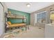 Cozy bedroom showcasing a bunk bed with yellow bedding, a colorful accent wall, and natural light at 1886 Makley Loop, Castle Rock, CO 80104