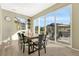 Sunny dining room featuring a large table, ample seating, and picturesque backyard views at 1886 Makley Loop, Castle Rock, CO 80104