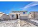 Two-story house with stone accents and snowy front yard at 1886 Makley Loop, Castle Rock, CO 80104