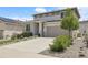 Attractive home showcasing a two-car garage, stone veneer, and lush landscaping at 1886 Makley Loop, Castle Rock, CO 80104