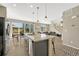 Open concept kitchen with granite island that flows into a large eating area and Gathering room at 1886 Makley Loop, Castle Rock, CO 80104