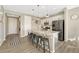Modern kitchen with a large granite island, stainless steel appliances, and stylish pendant lighting at 1886 Makley Loop, Castle Rock, CO 80104
