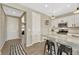 Bright kitchen features white cabinets, stainless appliances, and a convenient breakfast bar at 1886 Makley Loop, Castle Rock, CO 80104