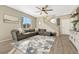 Cozy living room offering a comfortable sectional sofa, a stylish rug, and a staircase at 1886 Makley Loop, Castle Rock, CO 80104